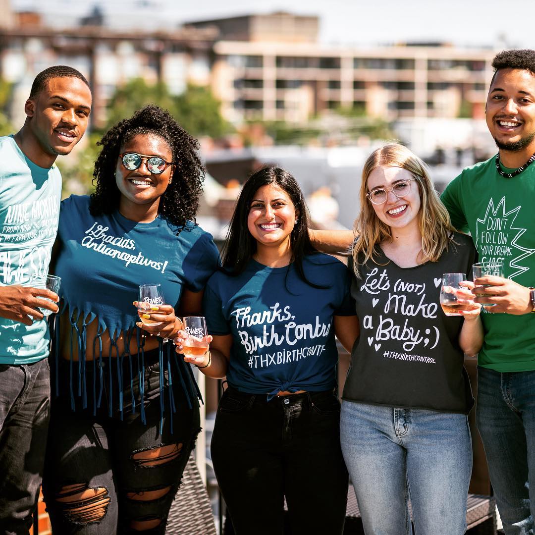 a group of people wearing various #thanksbirthcontrol shirts