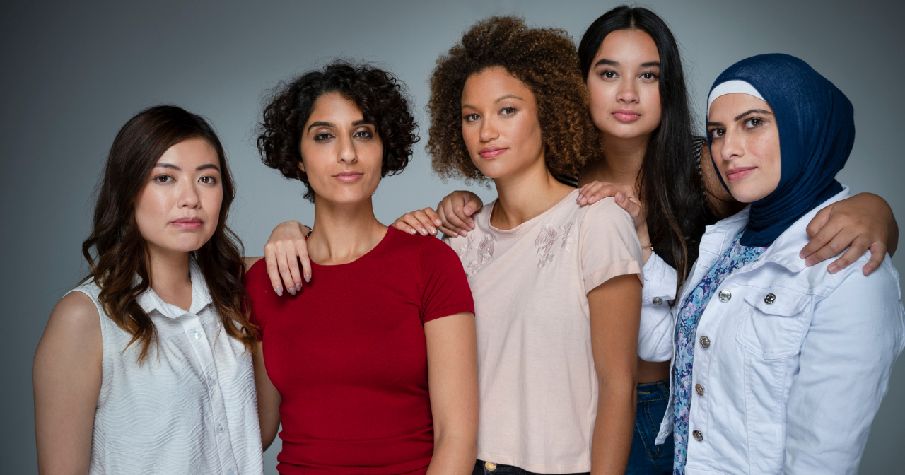 A group of diverse women posing for the camera