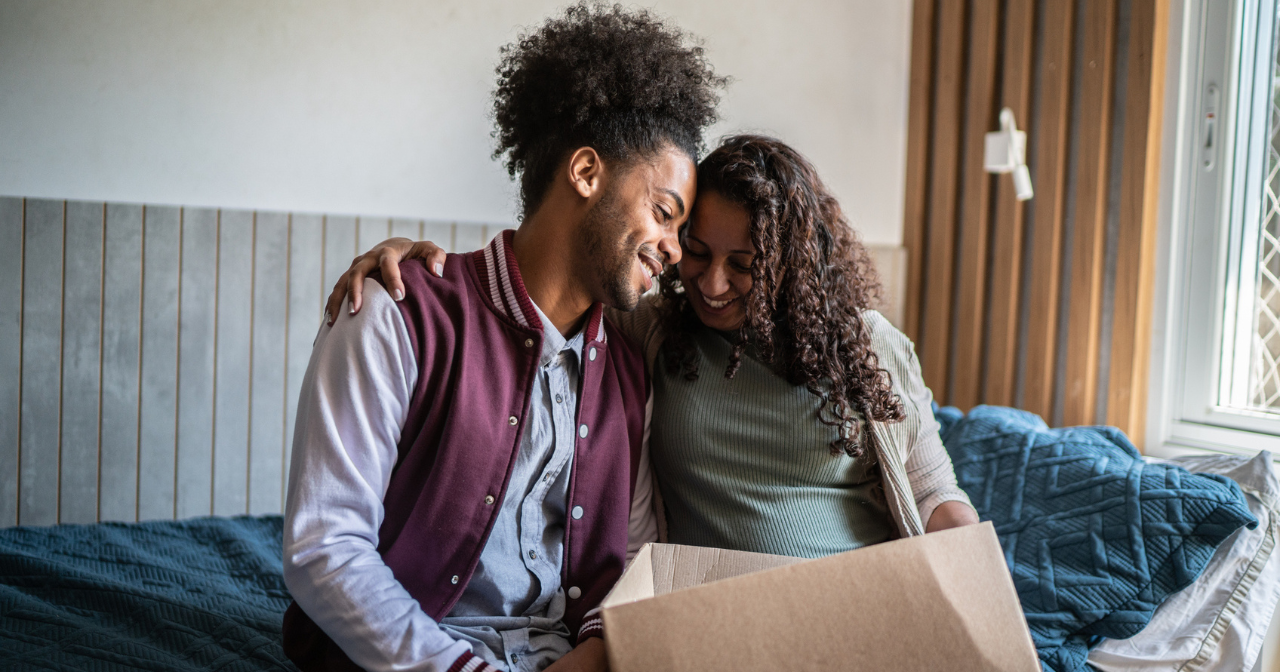 A mother and her son share a moment as they pack his things for him to move out of the house. 