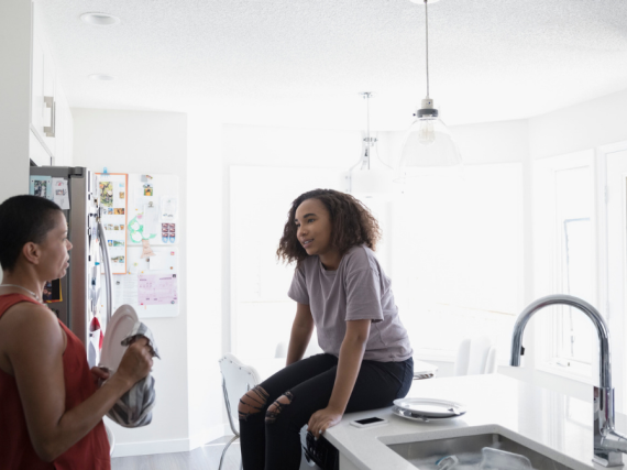 Mother and daughter talk in the kitchen
