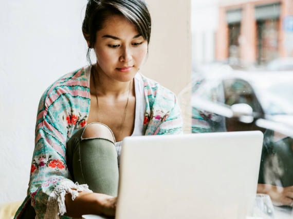 A woman sits calmly at her computer 