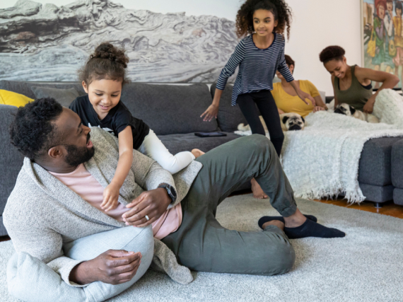 A large family enjoys spending time together on the sofa in their living room. 