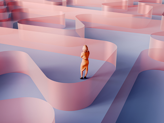 A woman stands in the midst of a large maze. 