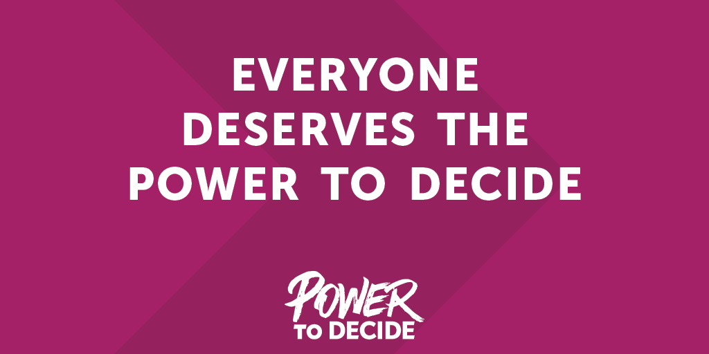 Pink sign that reads Everyone Deserves The Power to Decide